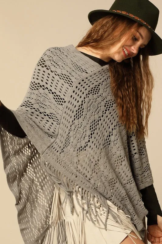 Lightweight crochet knit poncho in grey with tassel accent